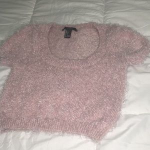 A pink feathered crop top